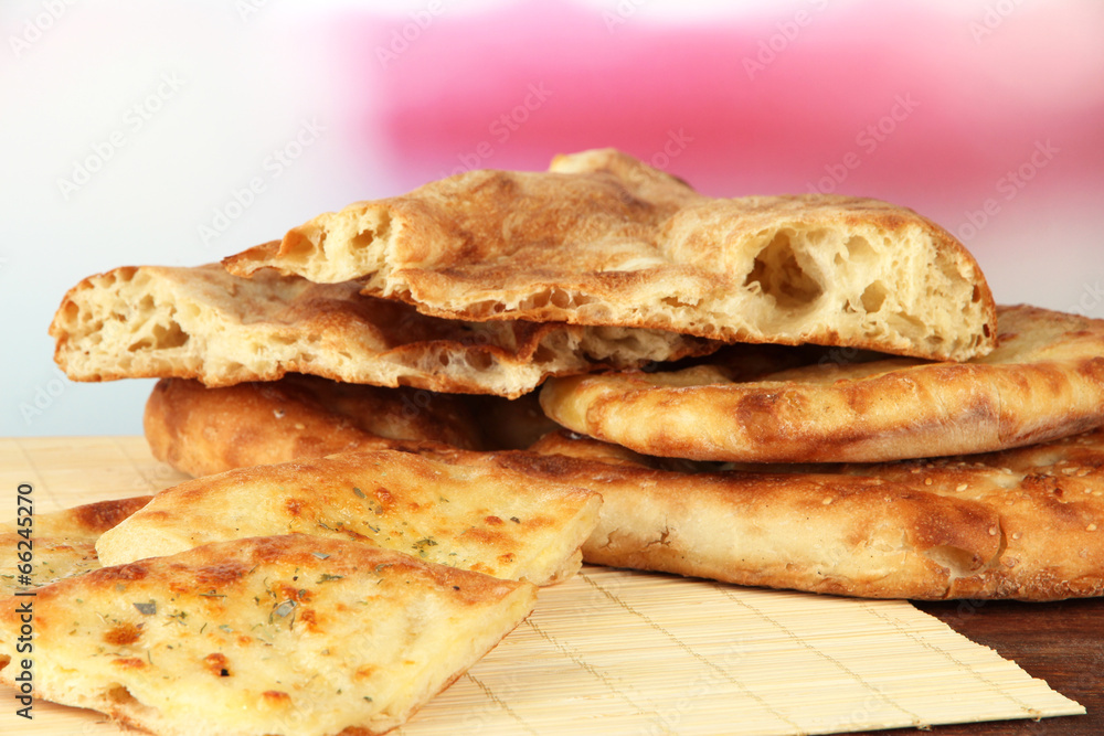 Pita breads on table on bright background Pita breads on table on bright background