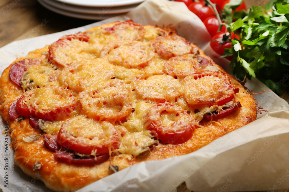 Homemade pizza on baking paper close up Homemade pizza on baking paper close up