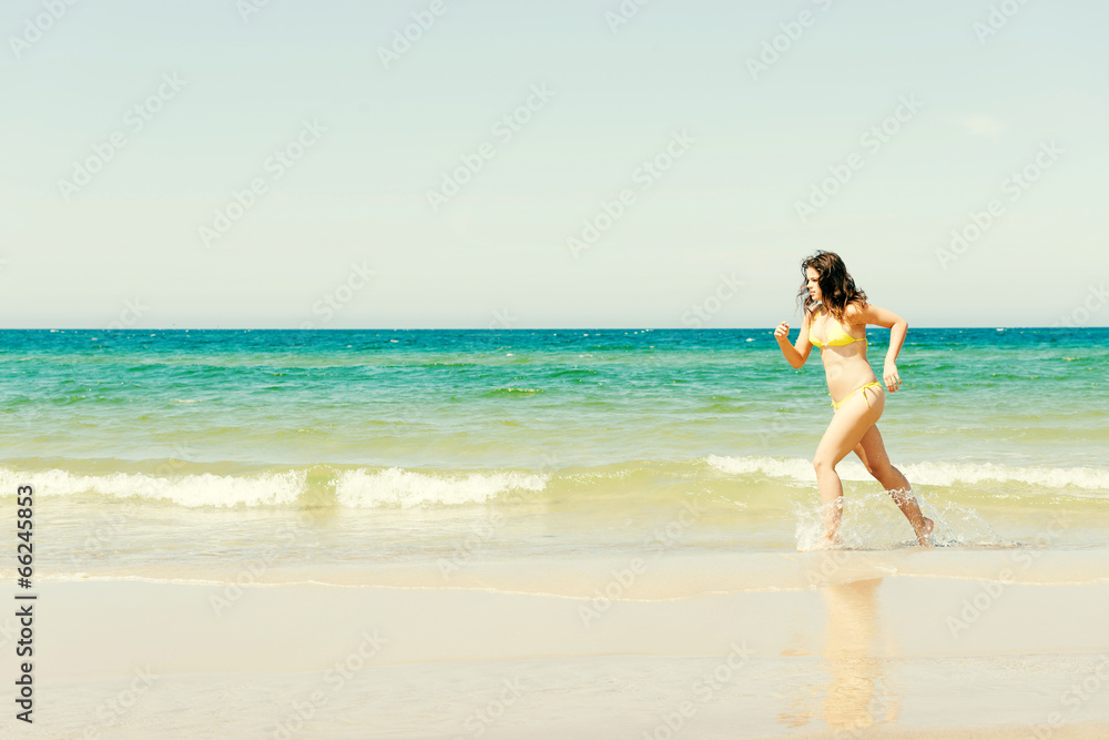 happy woman running on the beach