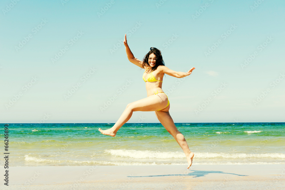 Happy girl jumping on the beach Happy girl jumping on the beach