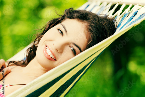 Young woman lying in a hammock