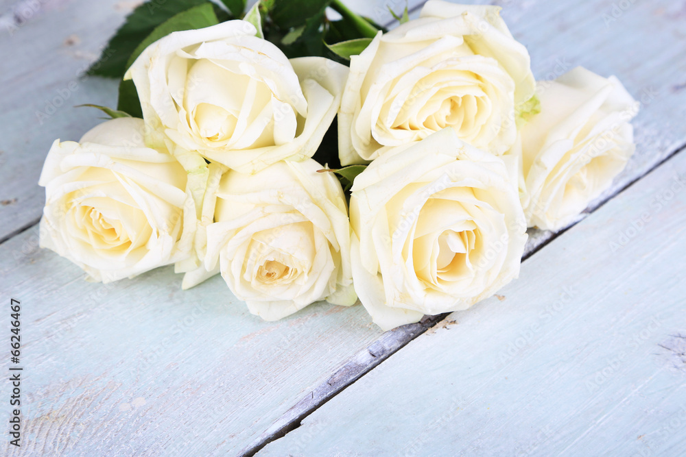 Beautiful white roses on wooden table Beautiful white roses on wooden table
