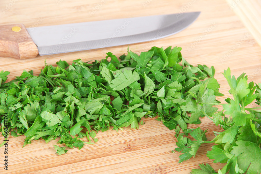 Chopped greens with knife on cutting board Chopped greens with knife on cutting board