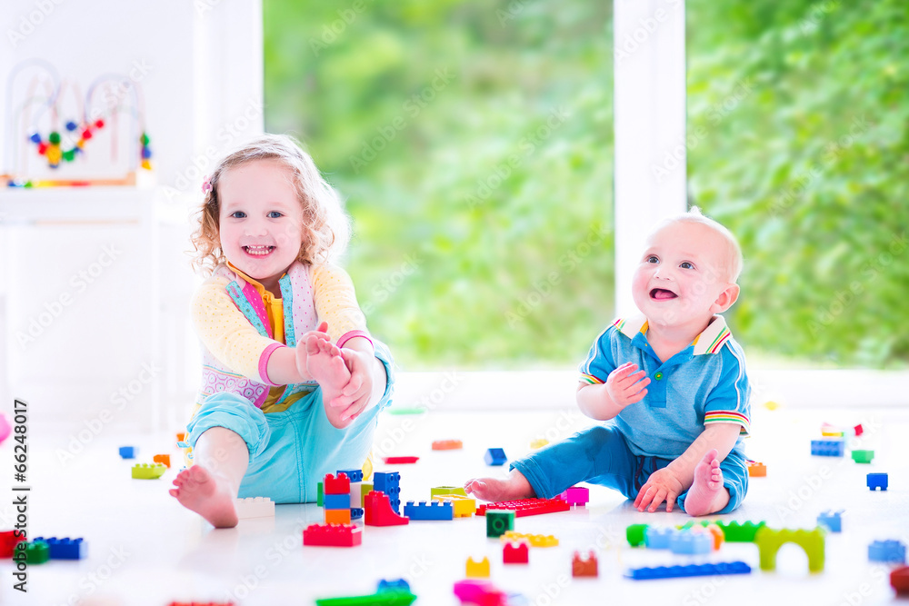 Brother and sister playing with colorful blocks Brother and sister playing with colorful blocks