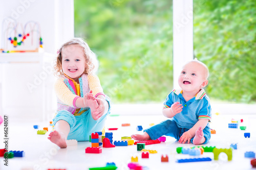 Brother and sister playing with colorful blocks