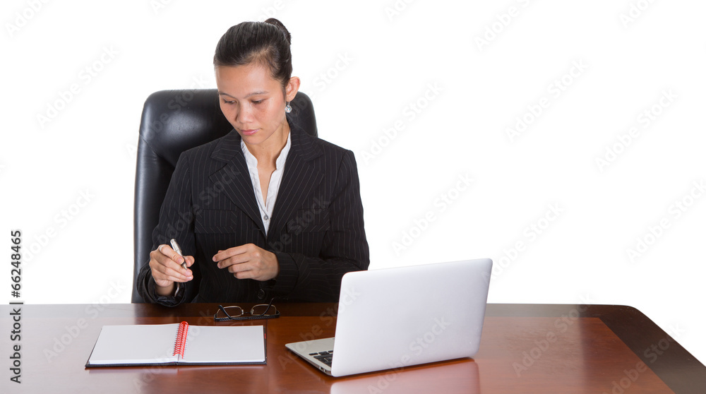 Asian businesswoman at her office desk over white background Asian businesswoman at her office desk over white background