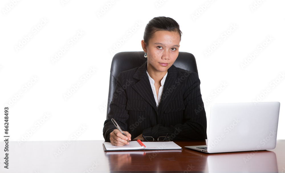 Asian businesswoman at her office desk over white background Asian businesswoman at her office desk over white background