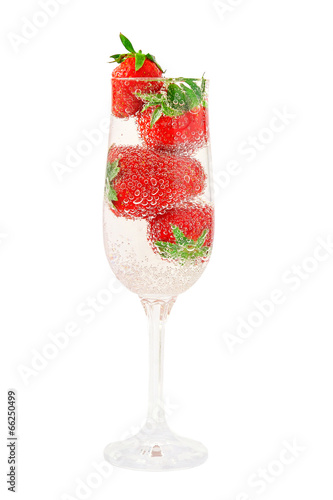 Elegant glass filled with mineral water with gas bubbles and jui