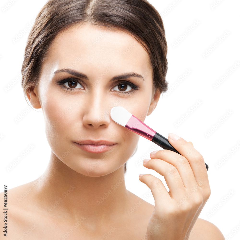 Smiling woman with make up brush, isolated Smiling woman with make up brush, isolated