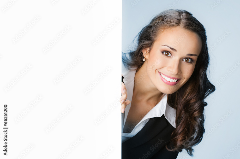 Businesswoman showing signboard, over blue Businesswoman showing signboard, over blue