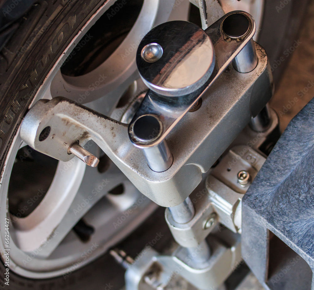 Car wheel fixed with computerized wheel alignment machine clamp Stock