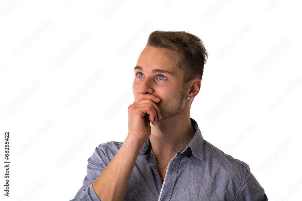 Dubious, unsure handsome blond young man