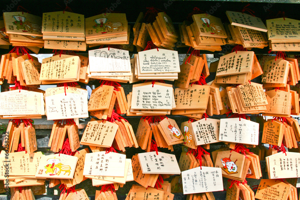 Small wooden plates with written wishes at Japanese temple