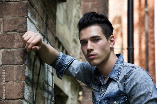 Handsome black haired young man in denim shirt