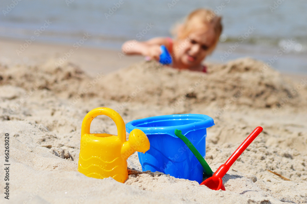 Little girl playing on the sand beach Little girl playing on the sand beach