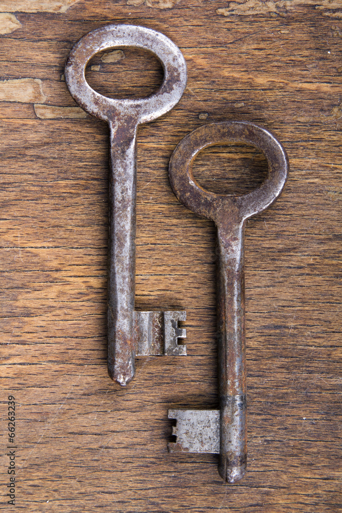 two rusty keys on wooden background two rusty keys on wooden background