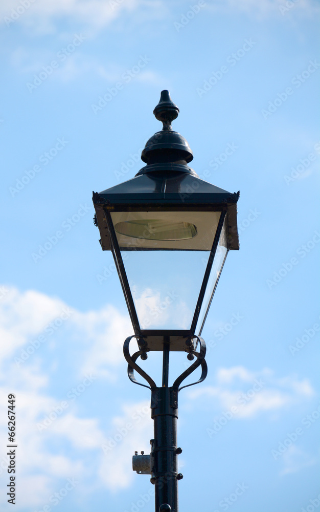 Vintage street light against a blue sky