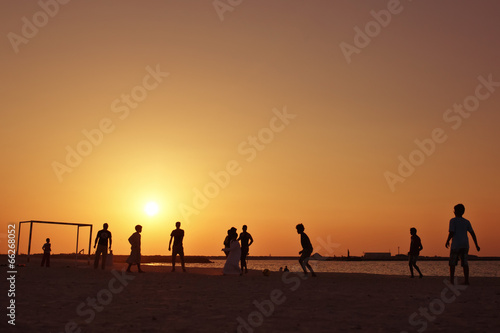 Football at  beach in Dubai during sunset.