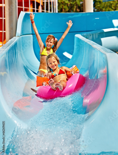 Child on water slide at aquapark. photo