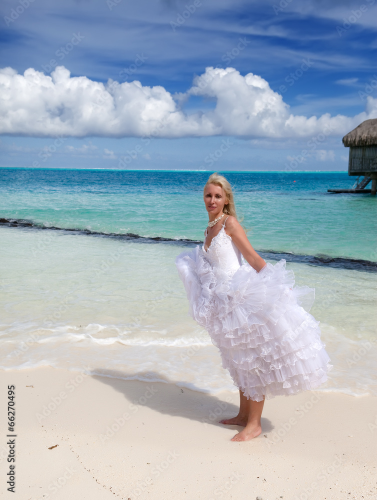 young beautiful woman in a bride dress standing at sea edge.. young beautiful woman in a bride dress standing at sea edge..