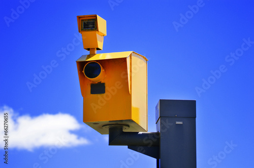 Bild auf Leinwand Traffic speed camera over the blue sky