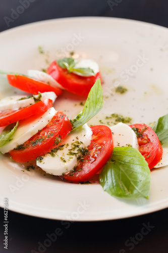 Tomato and mozzarella with basil leaves