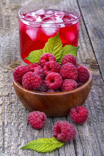 Healthy organic raspberries  with juice in the background