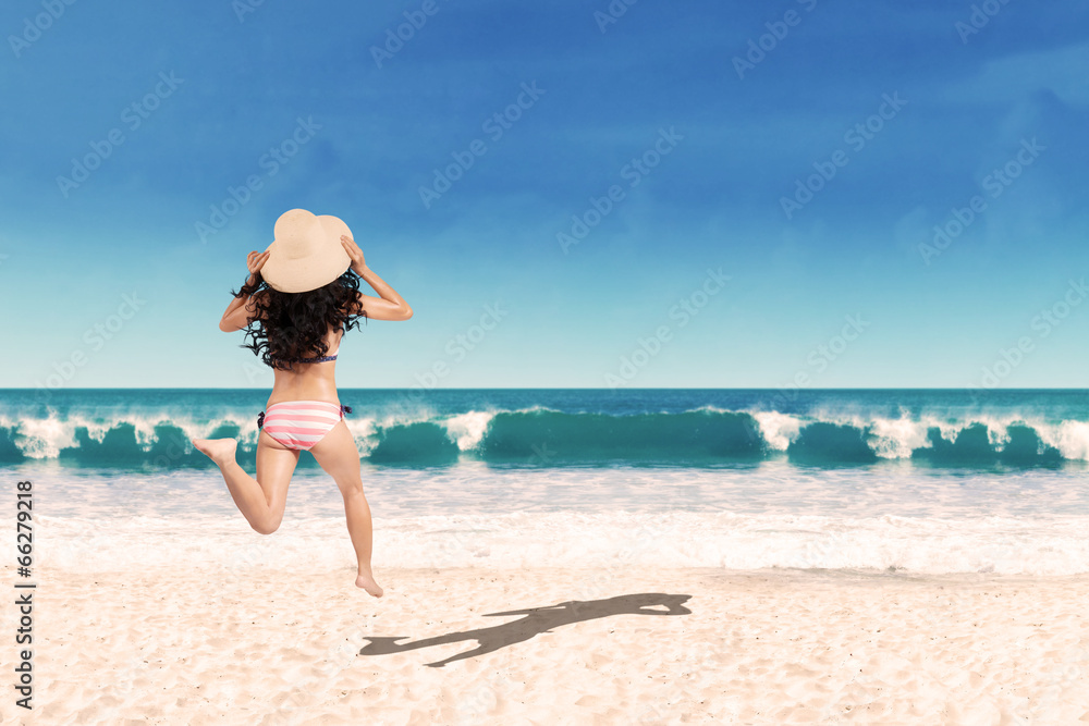 Excited woman running into the sea