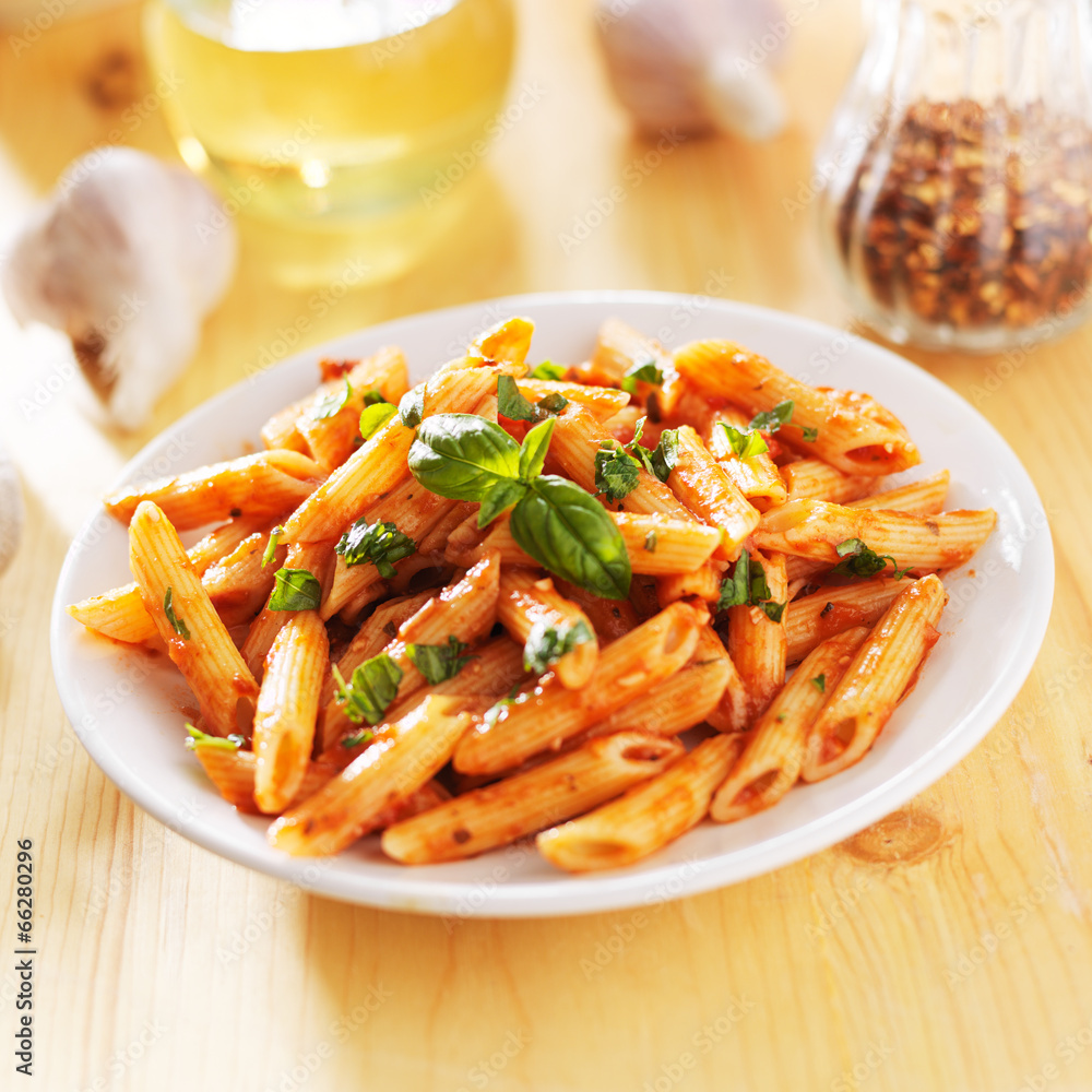 penne pasta smothered in tomato sauce