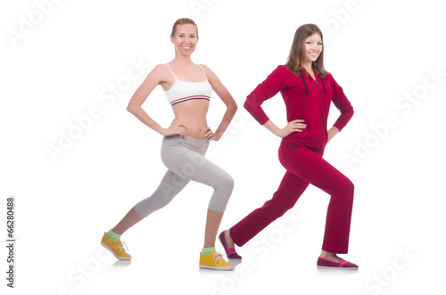 Pair of women doing exercises on white