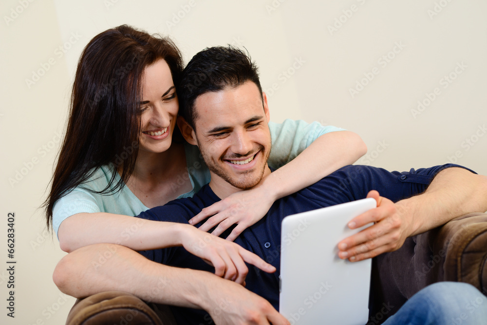 happy cheerful young couple home digital tablet together happy cheerful young couple home digital tablet together
