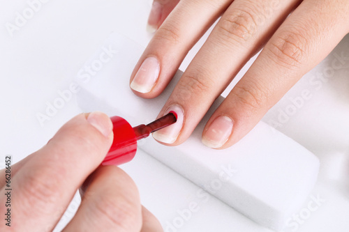 nail brush with red paint in the nail salon