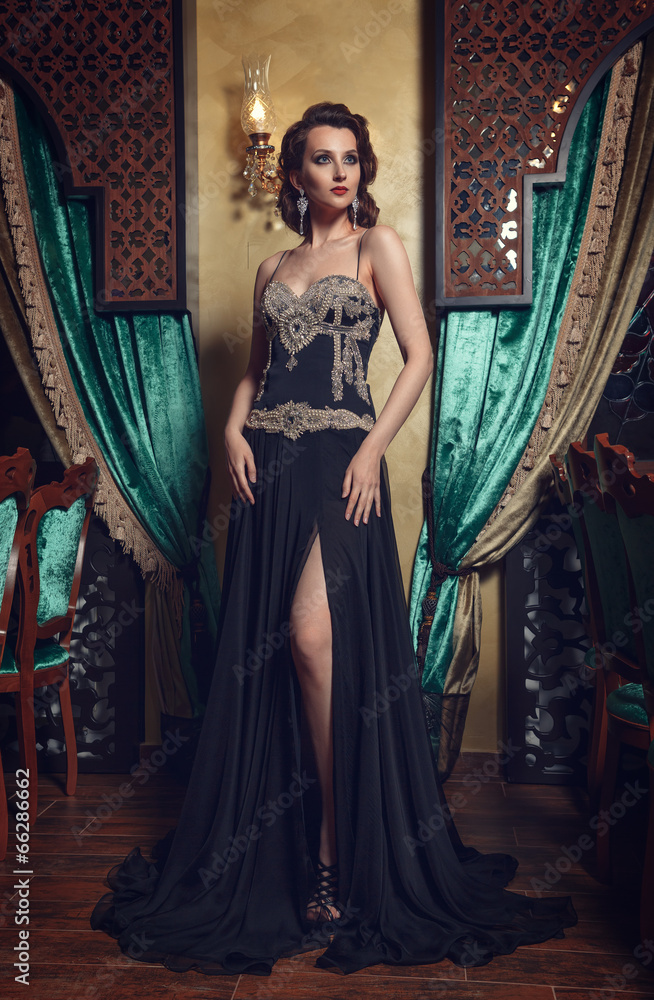 Fashion photo of young magnificent woman in black dress. Fashion photo of young magnificent woman in black dress.