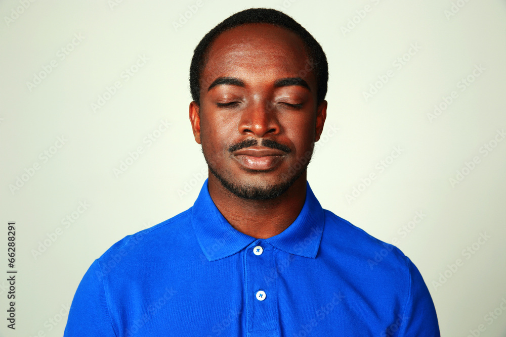 Fototapeta premium Portrait of a handsome african man isolated