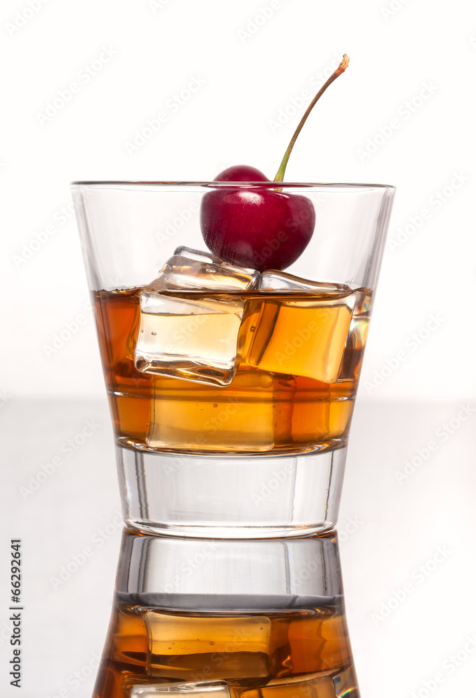 Glass with whiskey splash on white background Glass with whiskey splash on white background