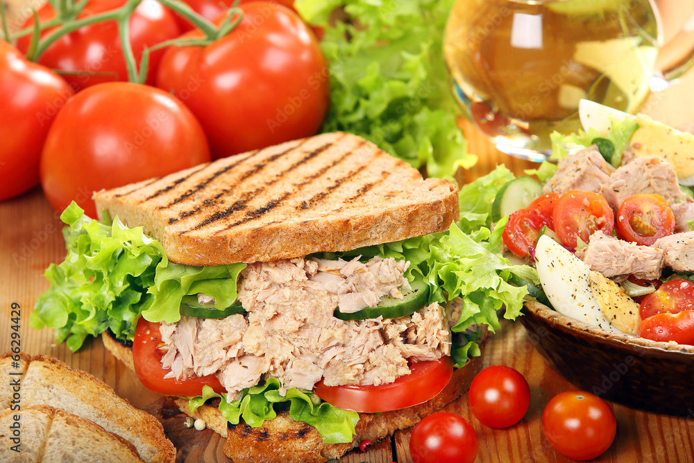 Sandwich with tuna and salad on wood background Sandwich with tuna and salad on wood background