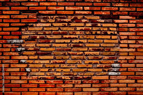 Old and dilapidated red brick wall