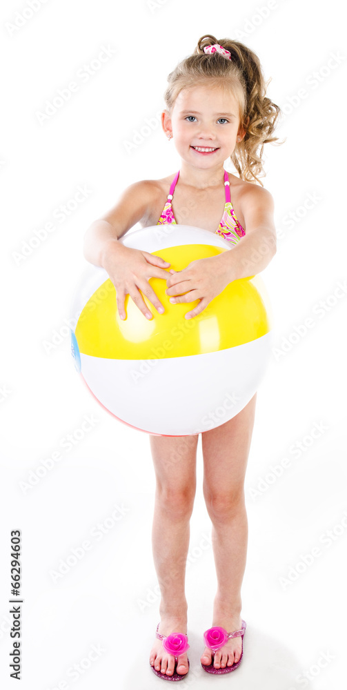 Cute smiling little girl in swimsuit holding ball isolated Cute smiling little girl in swimsuit holding ball isolated