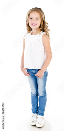 Cute smiling little girl in jeans isolated