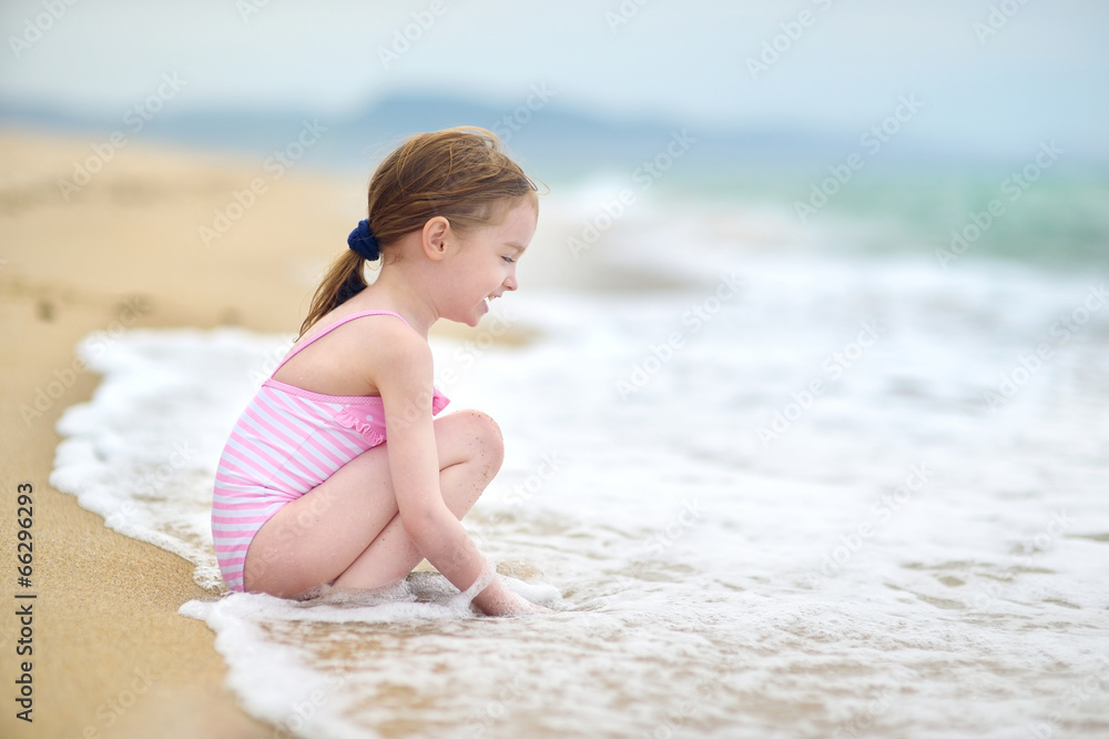 Cute little girl playing on a beach Cute little girl playing on a beach