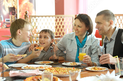 cute family eating pizza