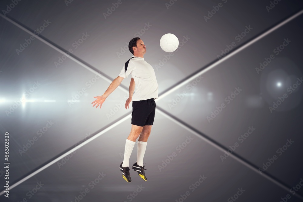 Fototapeta premium Composite image of football player in white jumping