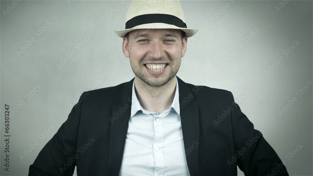 Happy man in hat and navy suit isolated on grey background Happy man in hat and navy suit isolated on grey background