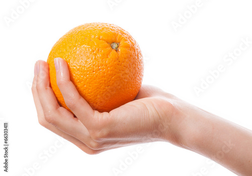 orange in a female hand