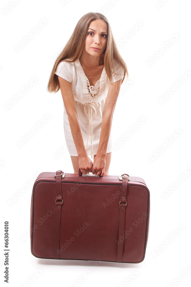 woman with a heavy suitcase, isolated on white woman with a heavy suitcase, isolated on white