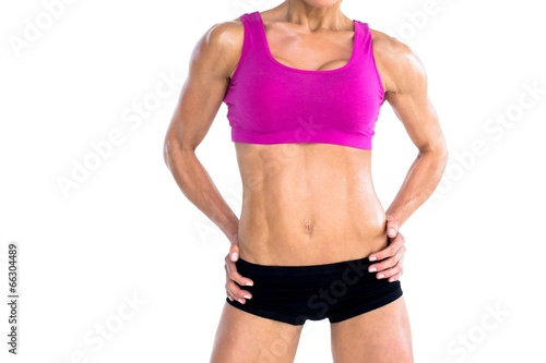 Female bodybuilder posing with hands on hips mid section © WavebreakmediaMicro