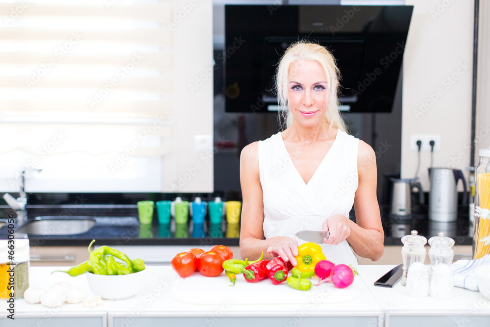 Happy woman cooks in the kitchen Happy woman cooks in the kitchen