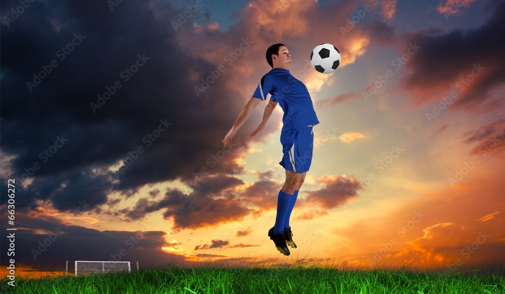 Composite image of football player in blue jumping Composite image of football player in blue jumping
