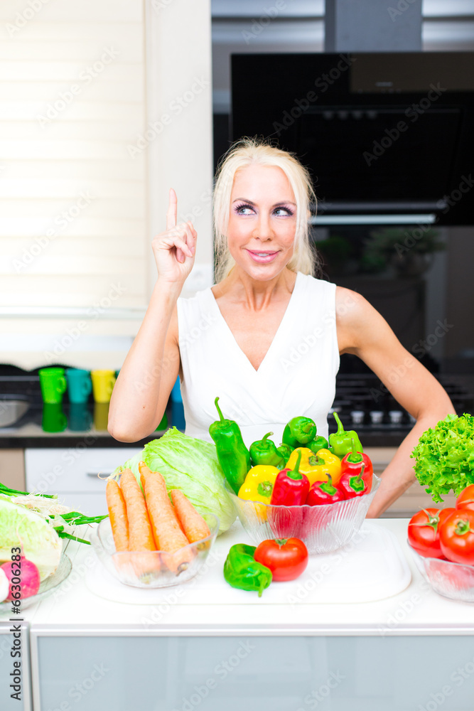 Happy woman cooks in the kitchen Happy woman cooks in the kitchen
