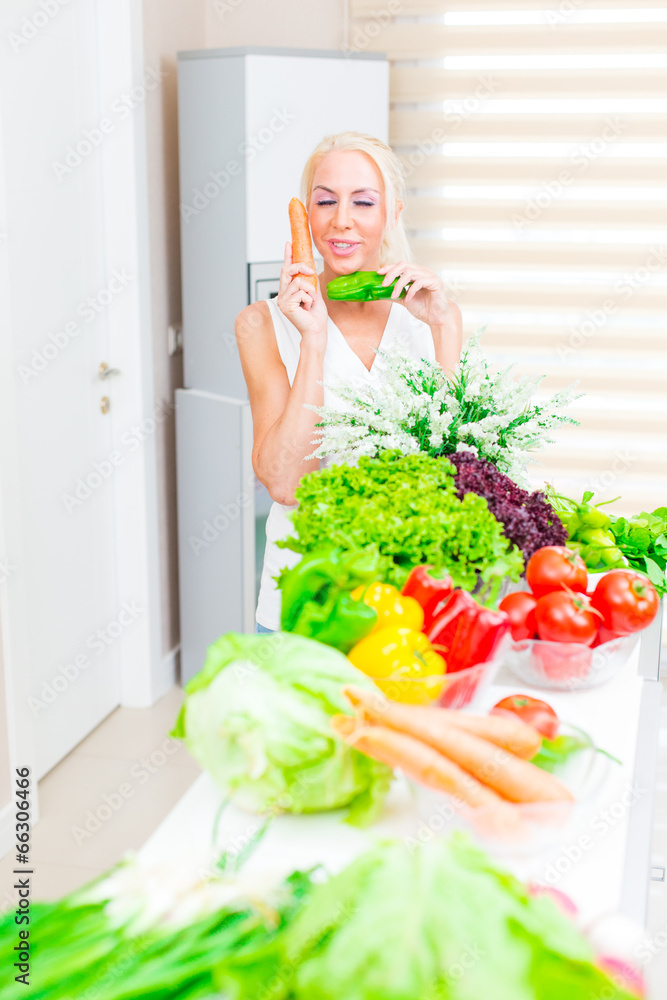 Happy woman cooks in the kitchen Happy woman cooks in the kitchen
